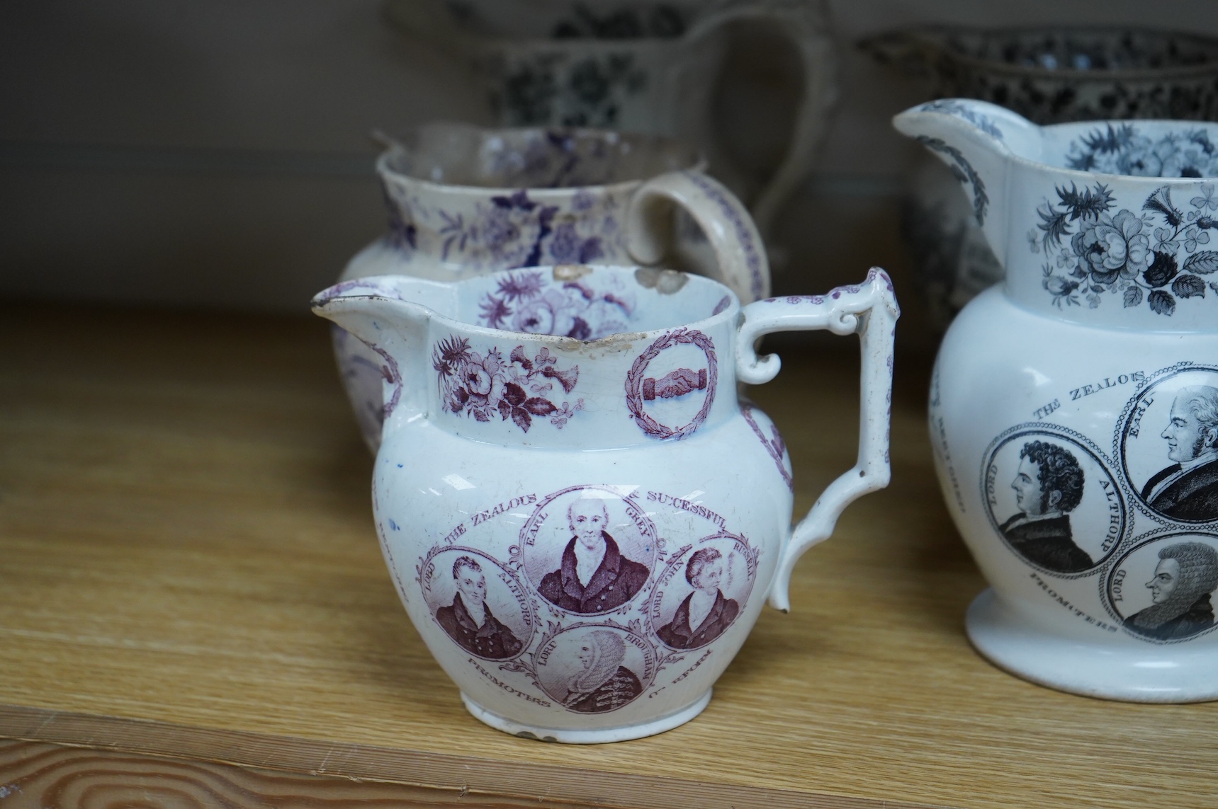 Six contemporary political themed earthenware pottery jugs and a pedestal bowl commemorating the 1832 Reform Bill, with transfer printed symbolic scenes of the Houses of Parliament, details regarding the voting, portrait